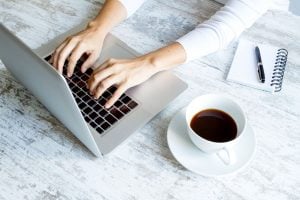 47933930 - working in the computer and drinking a coffee